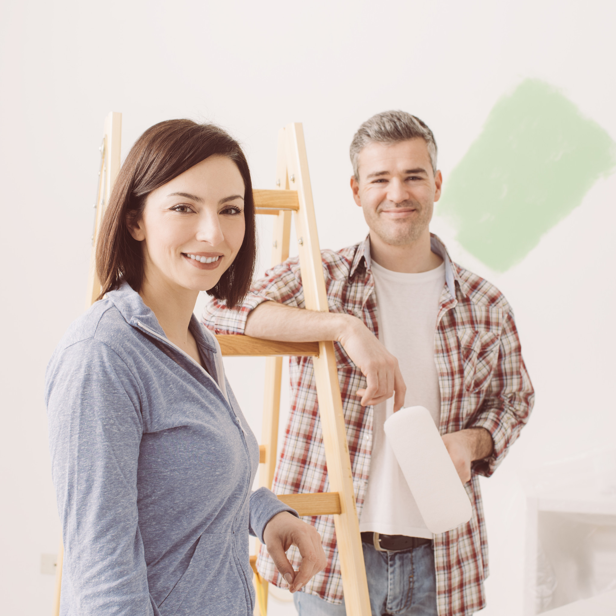 Couple painting their house